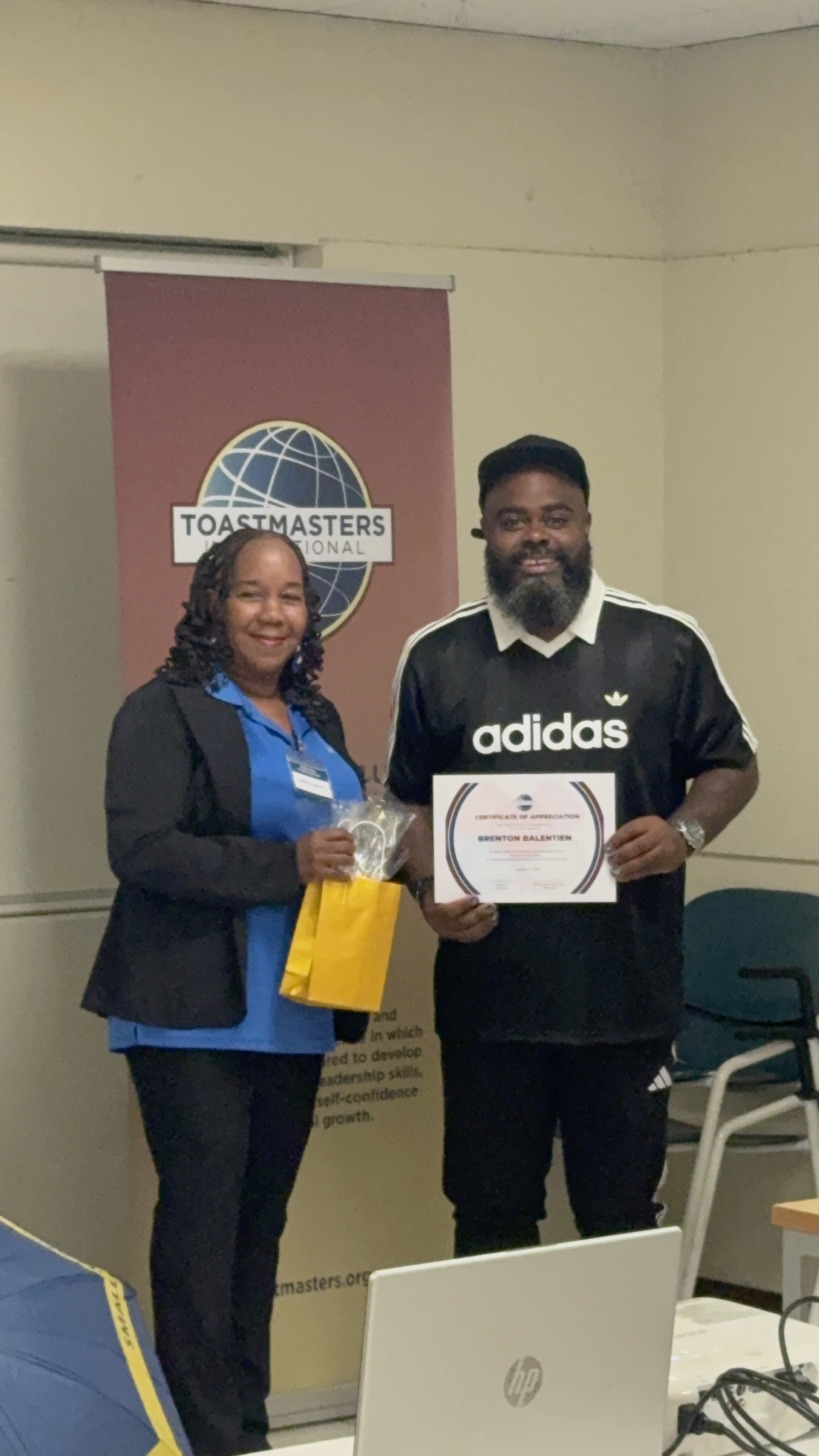 Brenton Balentien receiving a certificate of appreciation